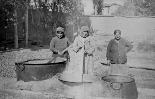 Three women work at the relief kitchen cauldrons. Harpoot, c. 1919-1922.