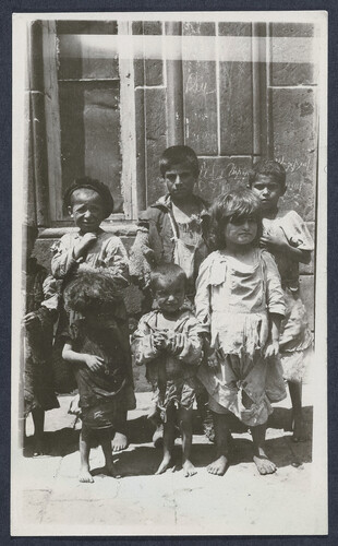 Ragged, barefoot children in a doorway. Alexandropol, c. 1923–1926.
