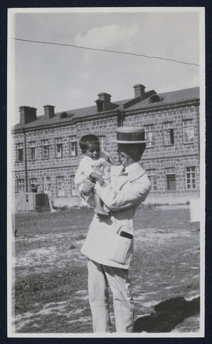 Barclay Acheson lifts a small child. Alexandropol, c. 1923