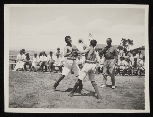 Boys boxing before a referee, US flag, Caucasus, 1920s