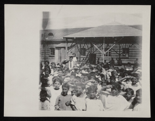 Relief worker amid a crowd of children, Caucasus, 1920s