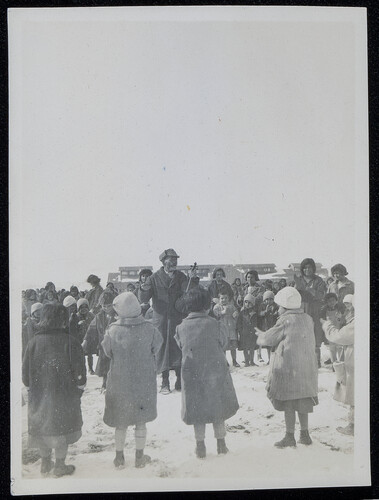Fiddler ringed by children in the snow, Caucasus, 1920s