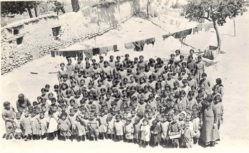 Emma Cushman's girls assemble in the yard. Konia, c. 1919–1920.