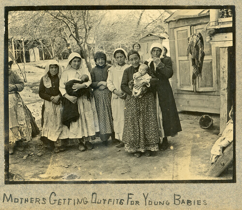 Mothers receiving outfits for babies