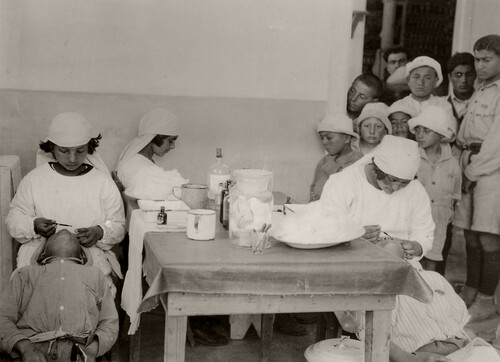 18 - Pupil nurses administering simple remedies.