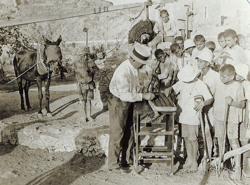 Fred Midgley teaching the boys to run a seed-sower, Syra