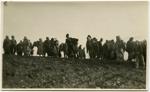 Armenian refugees leaving TurkeyA file of Armenian refugees with bundles crosses a bare ridge, fleeing Anatolia southward toward Aleppo and Beirut, c. 1921–1923.