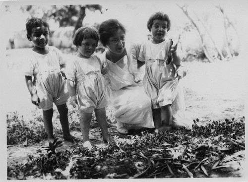 Nellie Miller crouches with three children. Sidon, c. 1923.