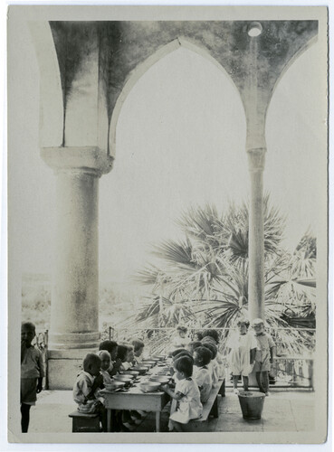 Children at prayer before dinner on the terrace of the Birds' Nest Orphanage in Sidon, ca. 1923.