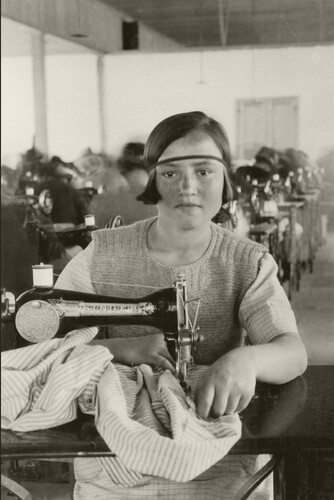 19 - Young girl working at a sewing machine 