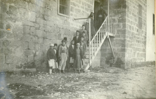 Children wait at the back door for clothing. Sidon, 1919–1920.