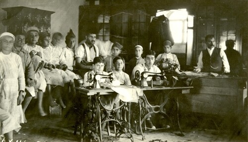 Treadle machines running in the tailor shop. c. 1919–1920.