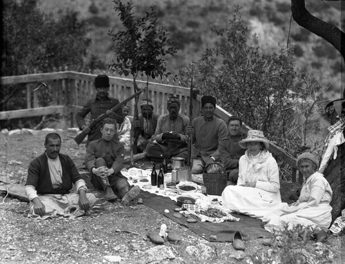 NER workers and armed escorts at outdoor picnic