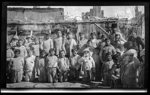 Children kneeling and standing under the grape arbor, Near East Relief orphanage, Marsovan (Merzifon).