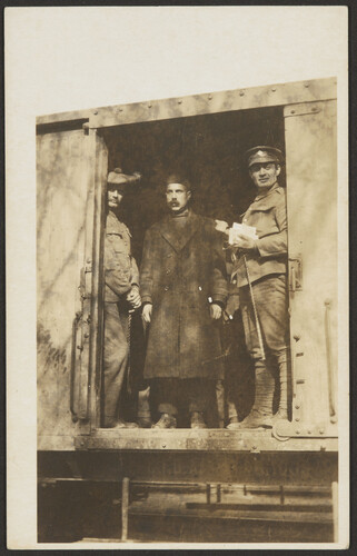 Three men in train car doorway