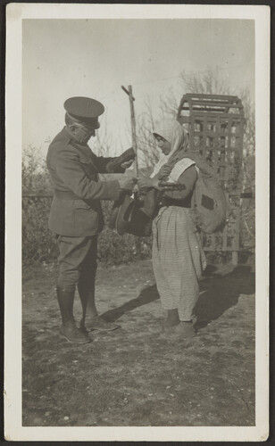 Dr. Wirt assisting Armenian woman carrying shoes, Marash