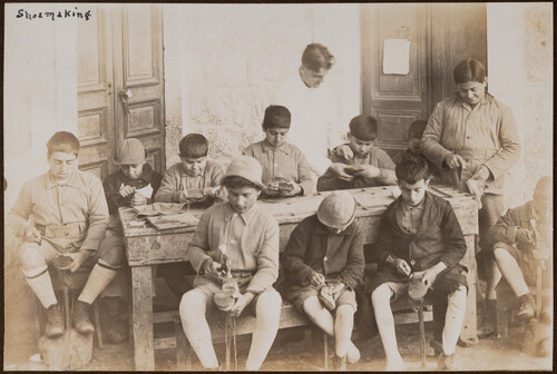 Boys make shoes at an outdoor bench. Ghazir, 1922.