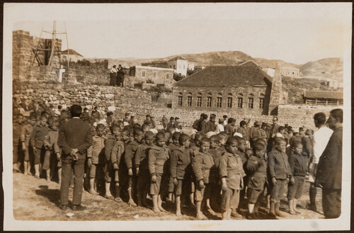 Small boys stand at attention in the yard. Jibail, 1922.