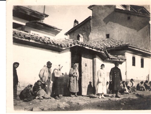 Refugees too weak to go on rest at the door. Sivas, 1922.
